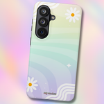 A phone case with a pastel rainbow gradient background, featuring white daisy flowers with yellow centers and wavy line details. The case is shown from a three-quarters perspective against a matching pastel rainbow gradient background.