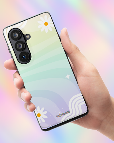 A hand holding a smartphone case with a pastel gradient design featuring white daisy flowers, wavy lines, and a black camera cutout, set against a soft rainbow-colored background.