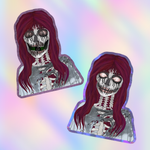 Two die-cut stickers featuring a stylized skeleton girl with long burgundy hair, shown on a pastel iridescent background.