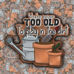 Illustration of gardening tools and plants with 'You're never too old to play in the dirt' text.