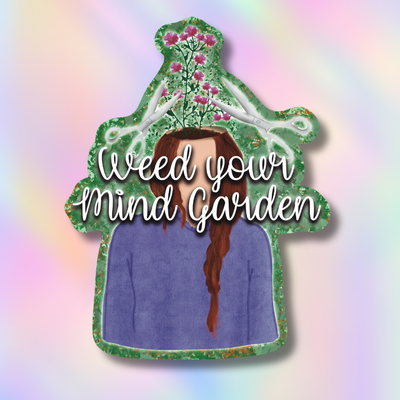 A die-cut sticker featuring an illustration of a person with long brown hair wearing a purple sweater, surrounded by green leaves and pink flowers, with the text 'Weed your Mind Garden' in white script. The sticker is shown against a pastel rainbow gradient background.