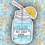A die-cut sticker of a mason jar filled with blue liquid, featuring a red-and-white striped straw, a yellow lemon slice, and a white banner reading 'Not paint water.' The sticker is centered over a repeating illustrated background of paint cans.