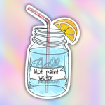 A die-cut sticker featuring a hand-drawn Ball Mason jar with a pink-and-white striped straw, a yellow lemon slice, and a white banner reading 'Not paint water.' The sticker is centered on a pastel rainbow gradient background.