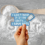 A hand holds a die-cut sticker with the text 'I can't help it if I'm salty.