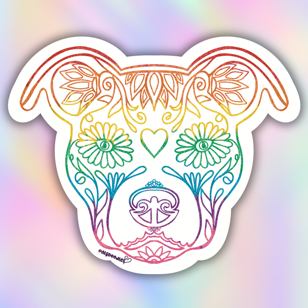 A die-cut vinyl sticker featuring a stylized dog head with ornate floral and decorative line art, filled with a rainbow gradient. The sticker is shown against a soft, iridescent pastel background.