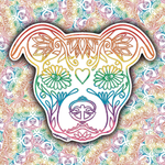 A die-cut sticker shaped like a dog head, decorated with colorful rainbow line art and floral motifs, shown against a busy multicolor patterned background.
