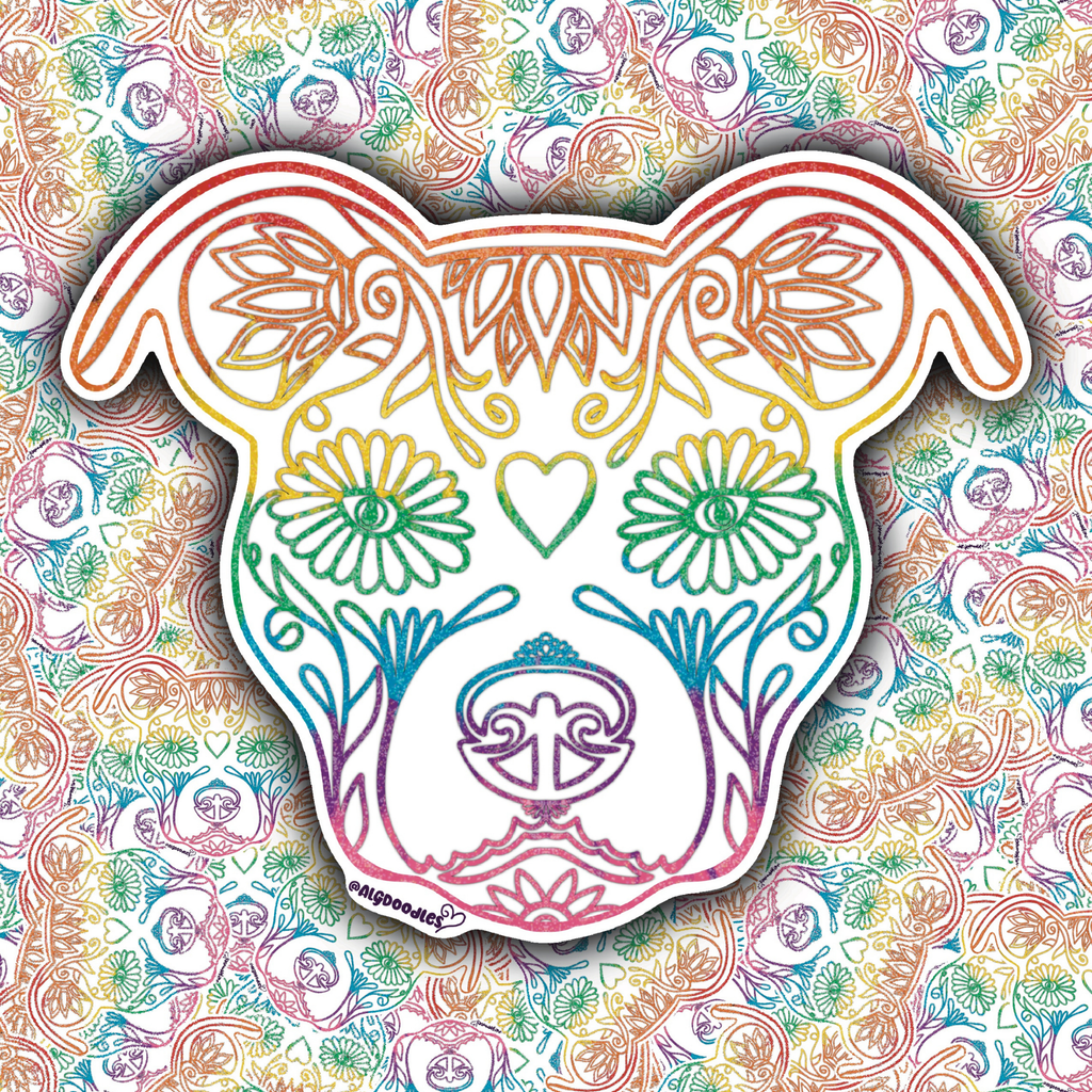 A die-cut sticker shaped like a dog head, decorated with colorful rainbow line art and floral motifs, shown against a busy multicolor patterned background.