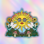 A colorful zendoodle die-cut sticker featuring a cartoon sun wearing sunglasses, surrounded by sunflowers, clouds, green leaves, and red-and-white mushrooms, set against a pastel iridescent background.