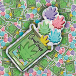 A die-cut sticker featuring a green marijuana leaf bag with the words 'Sweetleafs' and 'Kisses N' NUGS' printed on it, with three colorful flower-shaped candies popping out. The sticker is displayed on top of a background covered with multiple identical stickers.
