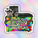 A die-cut vinyl sticker featuring two raccoons popping out of a brightly painted dumpster with the text 'YOUR OPINION IS TRASH'. The sticker is shown on a pastel rainbow gradient background.